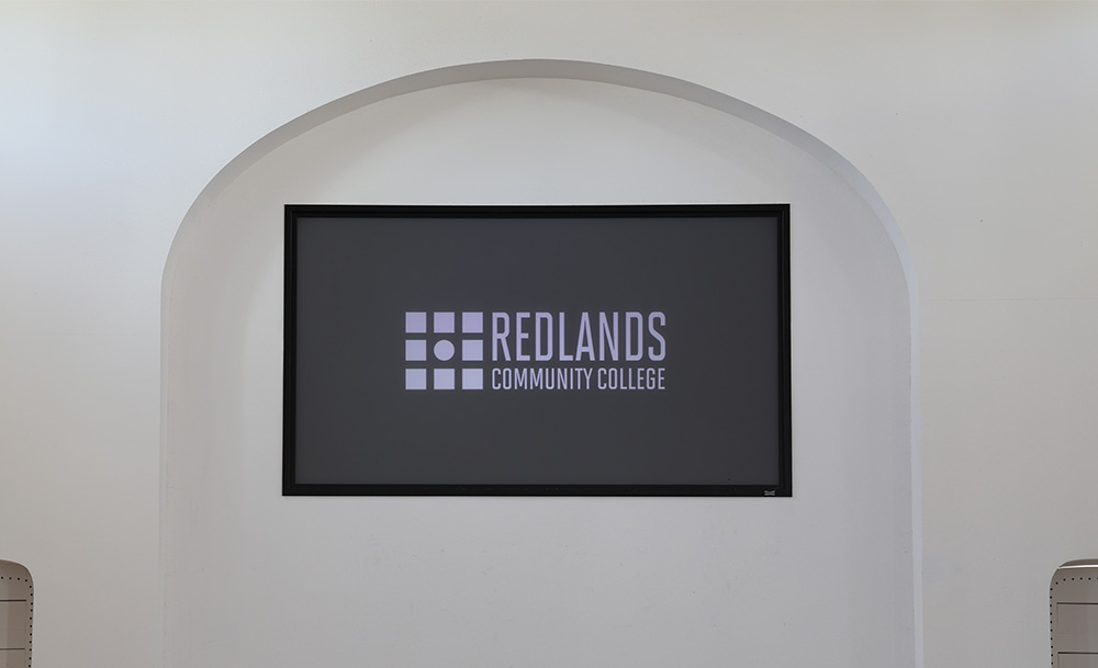 Projector screen located at the front and center of the main chapel room