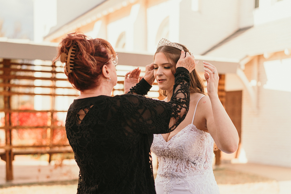 Adjusting a tiara in the courtyard